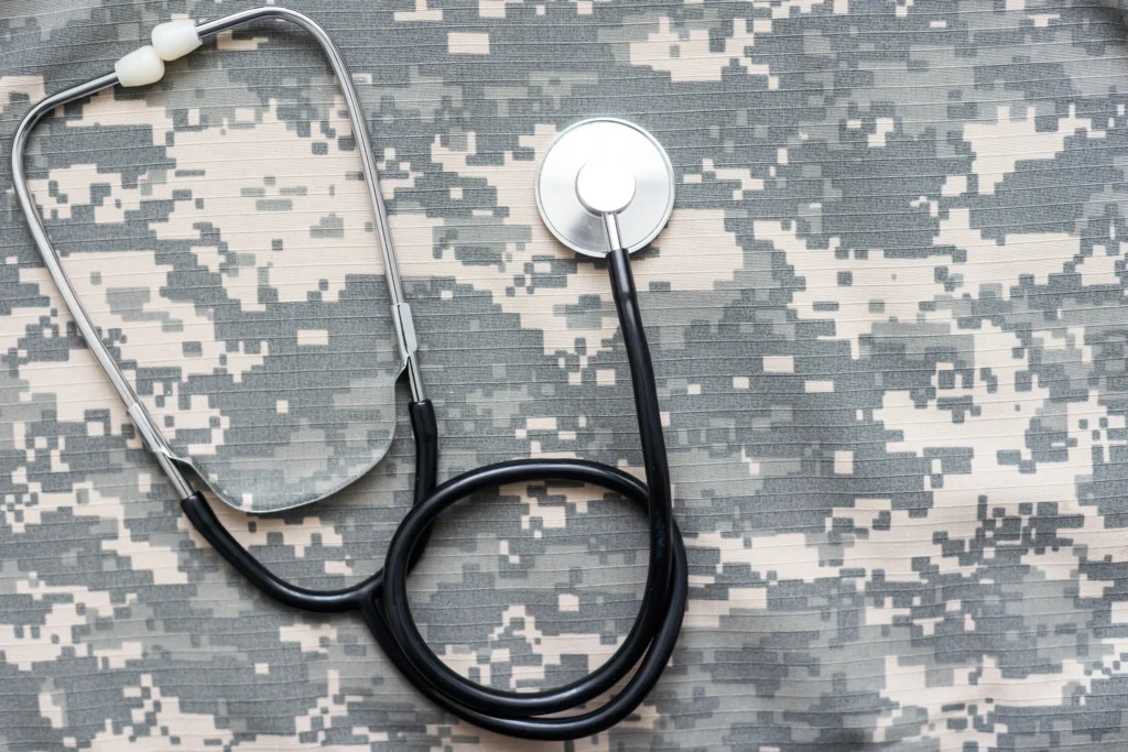 Military uniform fatigues and a stethoscope represent the medical case management services performed by HCRS for the Defense Health Agency.